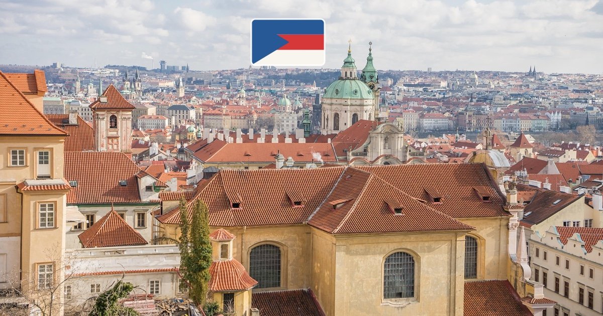 Prague historic skyline and rooftops with the Czech flag