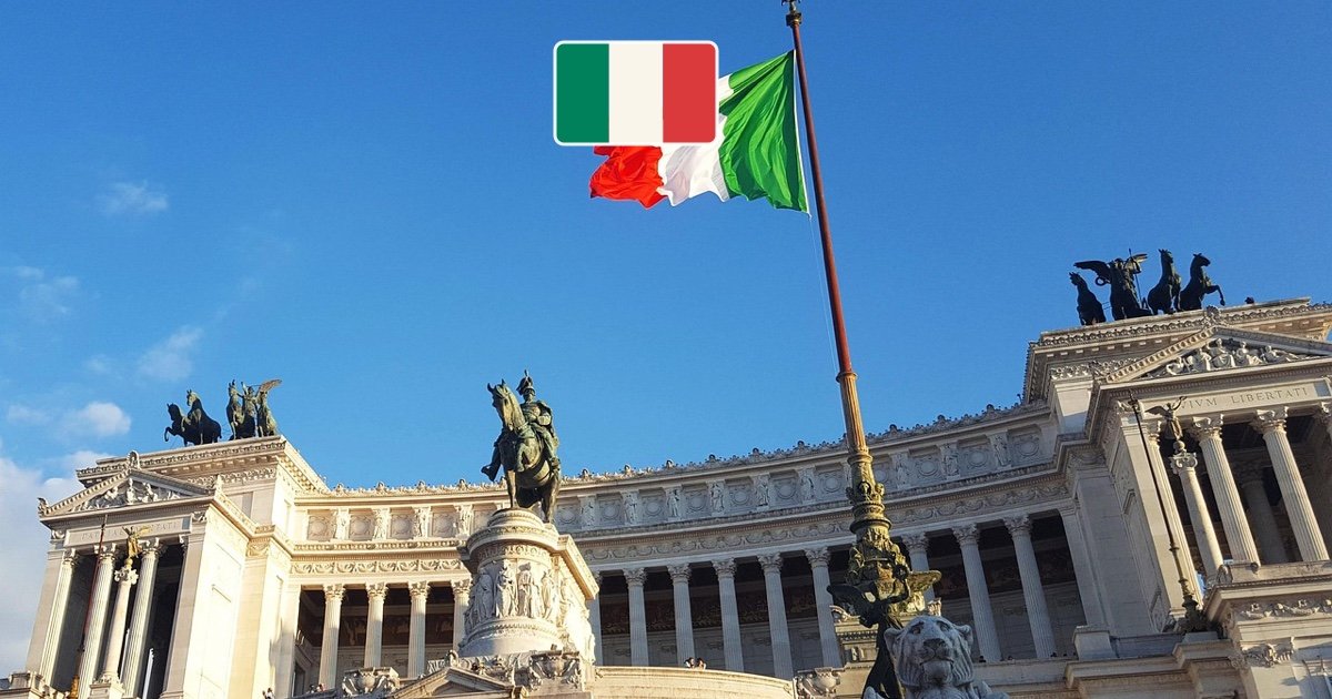 Rome monument with the Italian flag flying above the city