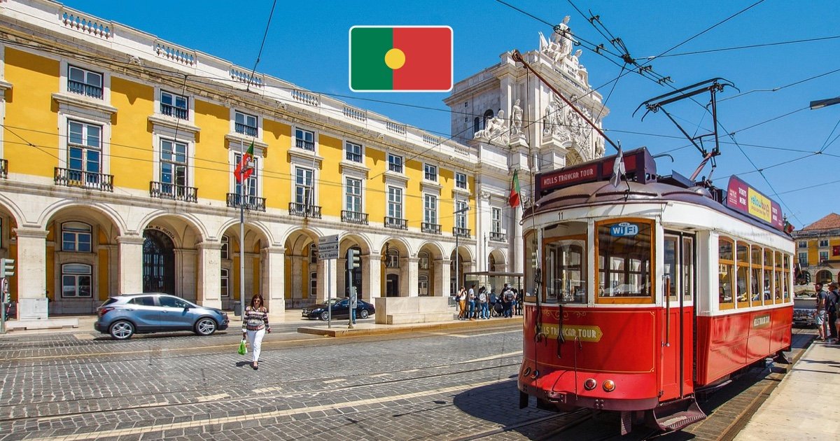 Lisbon tram and historic city architecture with the Portuguese flag